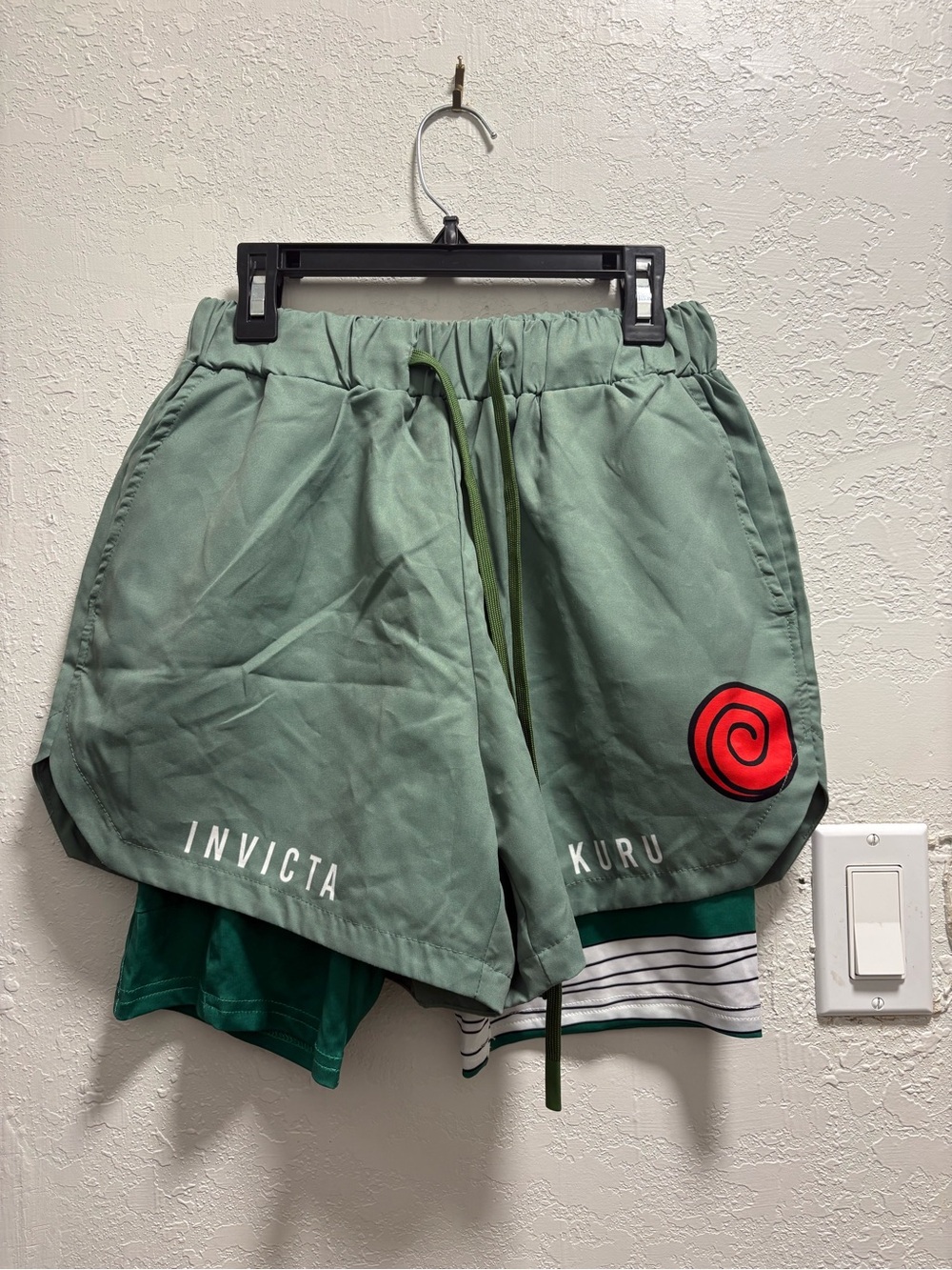 Invicta Men’s Sage Green Athletic Shorts with Red Spiral Accent